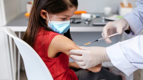 Little girl receiving coronavirus vaccine at doctor's office Little girl receiving coronavirus vaccine at doctor's office